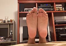 Gillian gives his feet a solo spin in tee and soles video