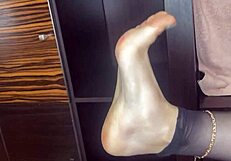 closeup foot in black stockings stroking anal beads