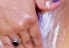 Amateur Solo Inserts Buttplug Into Shaved Wet Pussy In Shower