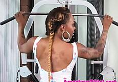 Busty Ebony Inked Transgender Girl in Crossdressing Outfit Stroking Her Large Cock with Tattoos Visible