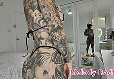 Melody Radford tries on a bright silver and blue skimpy micro bikini.