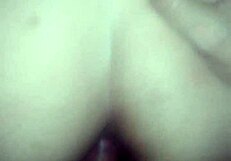 The couple enjoys anal doggystyle, bent over, leading to orgasm in her ass.