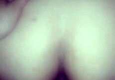 The couple enjoys anal doggystyle, bent over, leading to orgasm in her ass.