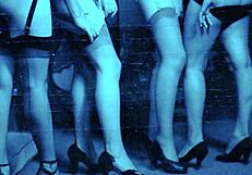 Vintage lingerie model showcases retro stockings and antique pieces