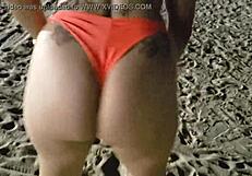 Look at this blonde showing her tits and pussy on the beach!