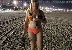 Look at this blonde showing her tits and pussy on the beach!