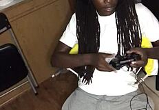 Ebony babe gives head while gaming