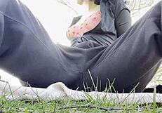 A naughty brunette teen masturbates to orgasm in the public park