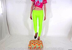 Beautiful legged woman steps on cushion with high heels, showcasing her shoe fetish.