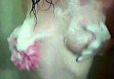 Beautiful redhead masturbates in the shower, fingering her wet pussy.