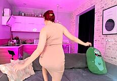 Beautiful cute redhead dances seductively, undressing slowly while fingering her wet pussy and masturbating her legs.