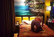 Peruvian girl in red corset poses with her amateur couple at home