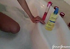 Blonde teen gives footjob in home video