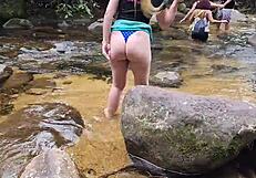 Strolling casually by the waterfall with a stunning big ass