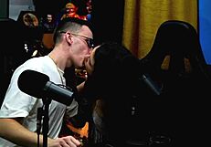 A husband of Natasha Naturist looks at Ruan as the latter kisses the lady during a beach casting session