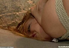 The blond is gagged and bound, getting roughly fucked with a monster cock