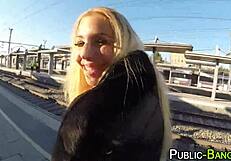 Blonde slut with big tits titfucks and gives handjob in public outdoor setting.