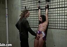 Seductive dark-haired girl punished and getting an orgasm in a dungeon