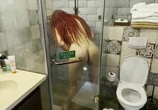 Redhead girl shaves her body in the shower after swimming in the pool