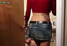 Busty tattooed milf jerks cock in toilet cfnm