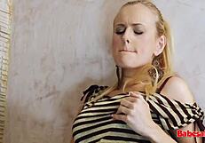 Hot blonde babe with big tits gives foot job in the bath.