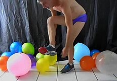 Mature gay DILF Richard Lennox plays with balloons during session