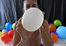 Mature gay DILF Richard Lennox plays with balloons during session