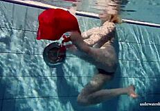 Russian teen Lucie enjoys underwater swimming in the pool.