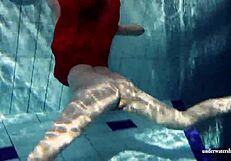 Russian teen Lucie enjoys underwater swimming in the pool.