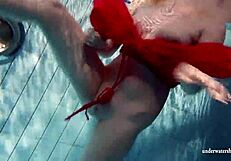 Russian teen Lucie enjoys underwater swimming in the pool.