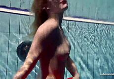 Russian teen Lucie enjoys underwater swimming in the pool.