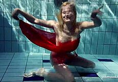 Russian teen Lucie enjoys underwater swimming in the pool.