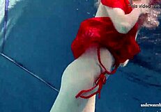 Russian teen Lucie enjoys underwater swimming in the pool.