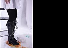 The boot crushes food in a fetish scene, leaving messy remains on the floor.