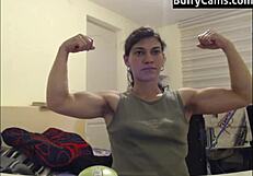 Athletic bodybuilder flexes biceps on camera