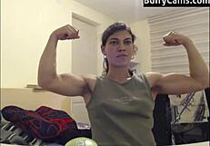 Athletic bodybuilder flexes biceps on camera