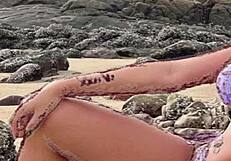 African beauty in bikini on the beach gets me jerking off.