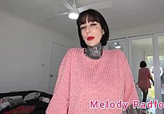 Melody Radford tries on short black and red lingerie skirt closeup.