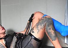 Asian goddess with tattoos and piercings rocks dominatrix outfit with short cast legs.