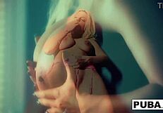 I watch Britney Amber masturbate against the blue wall, her big tits bouncing