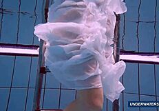 Amazing brunette shows off hairy body in underwater bikini.