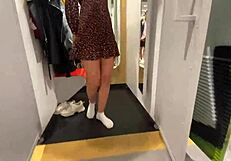 The girl works out a purchase in the locker room with her couple