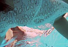 White-dressed tight hairy babe Katy Soroka swimming underwater in pool.