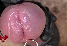 Extreme close-up of latex gloves on peehole with intense cumshot