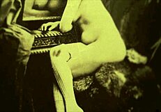 in this retro scene, a woman undresses and gives a blowjob