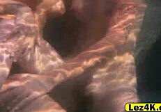 Sexual promiscuous women entice one another sexually through sceneful seductive lesbian acts in water