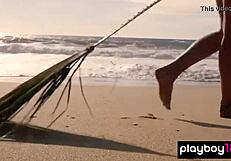 busty inked beauty in bikini stripping on the beach