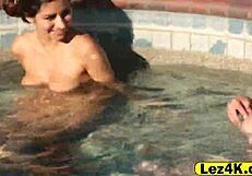 Sexual promiscuous women entice one another sexually through sceneful seductive lesbian acts in water