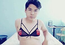 The hot young gay guy touches himself in his room while crossdressing