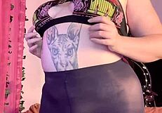 Woman in heels and leggings masturbates in black pantyhose